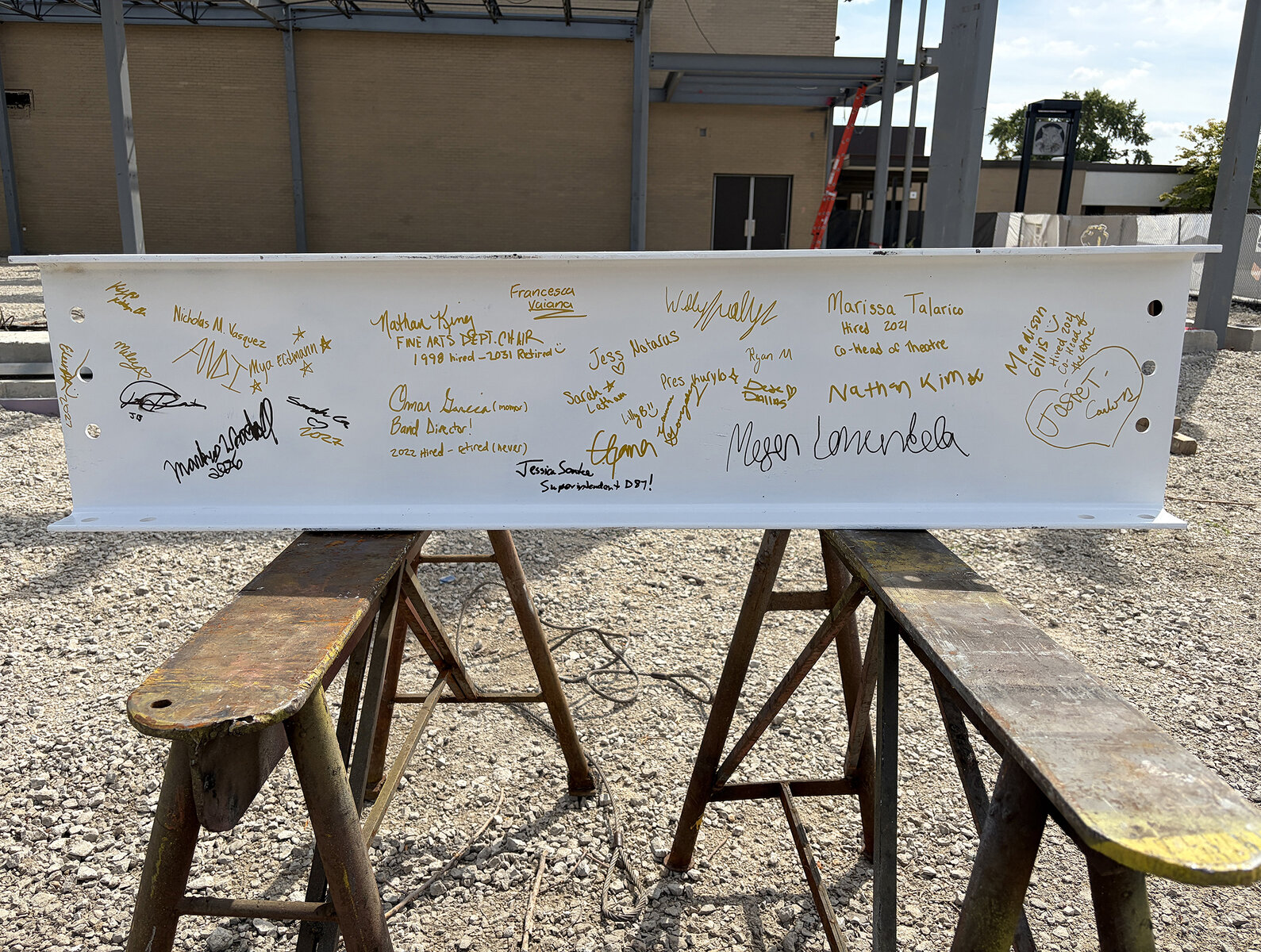 Photo of Glenbard North steel topping off piece with signatures